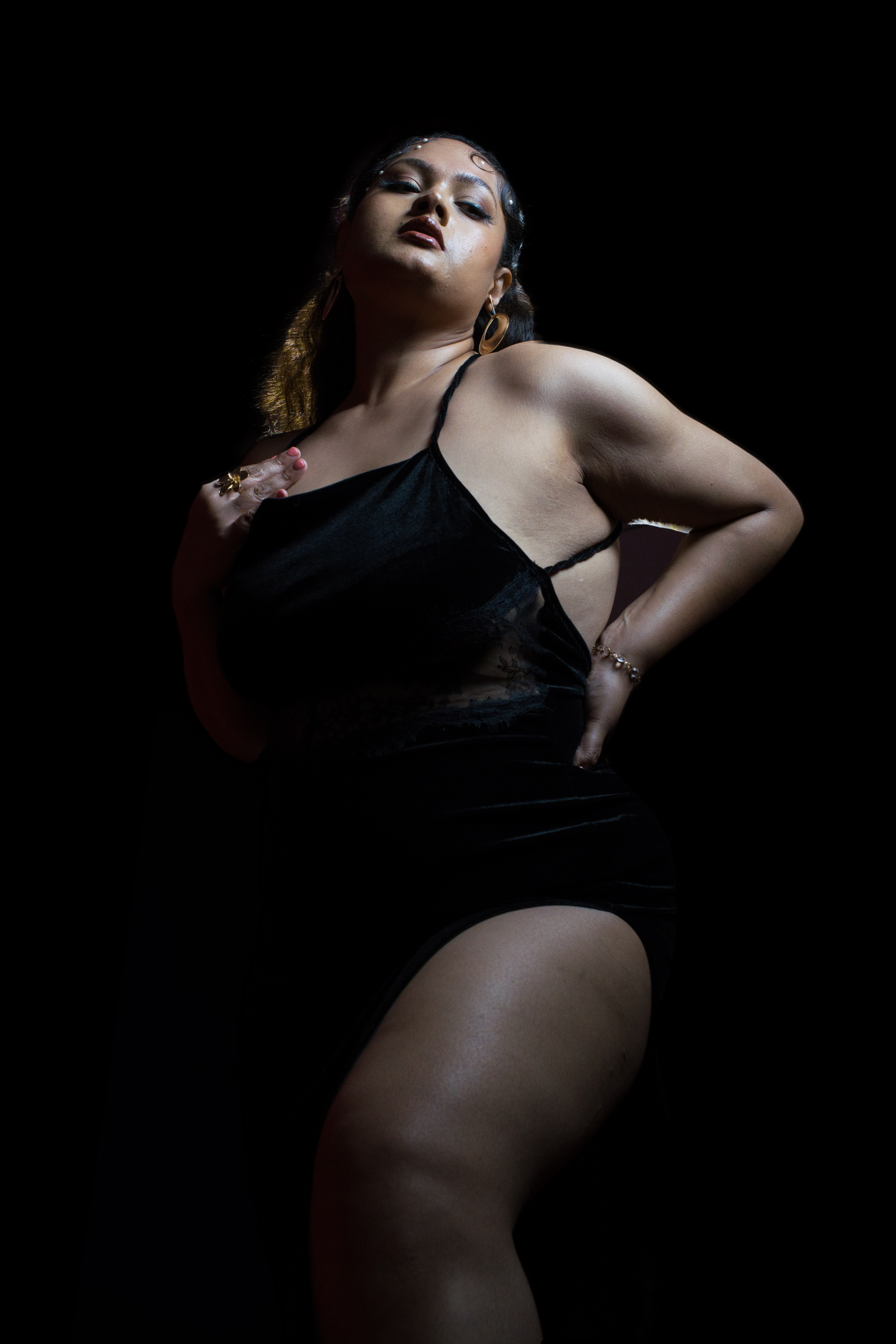 Model in low-key crimson light, sculptural pose