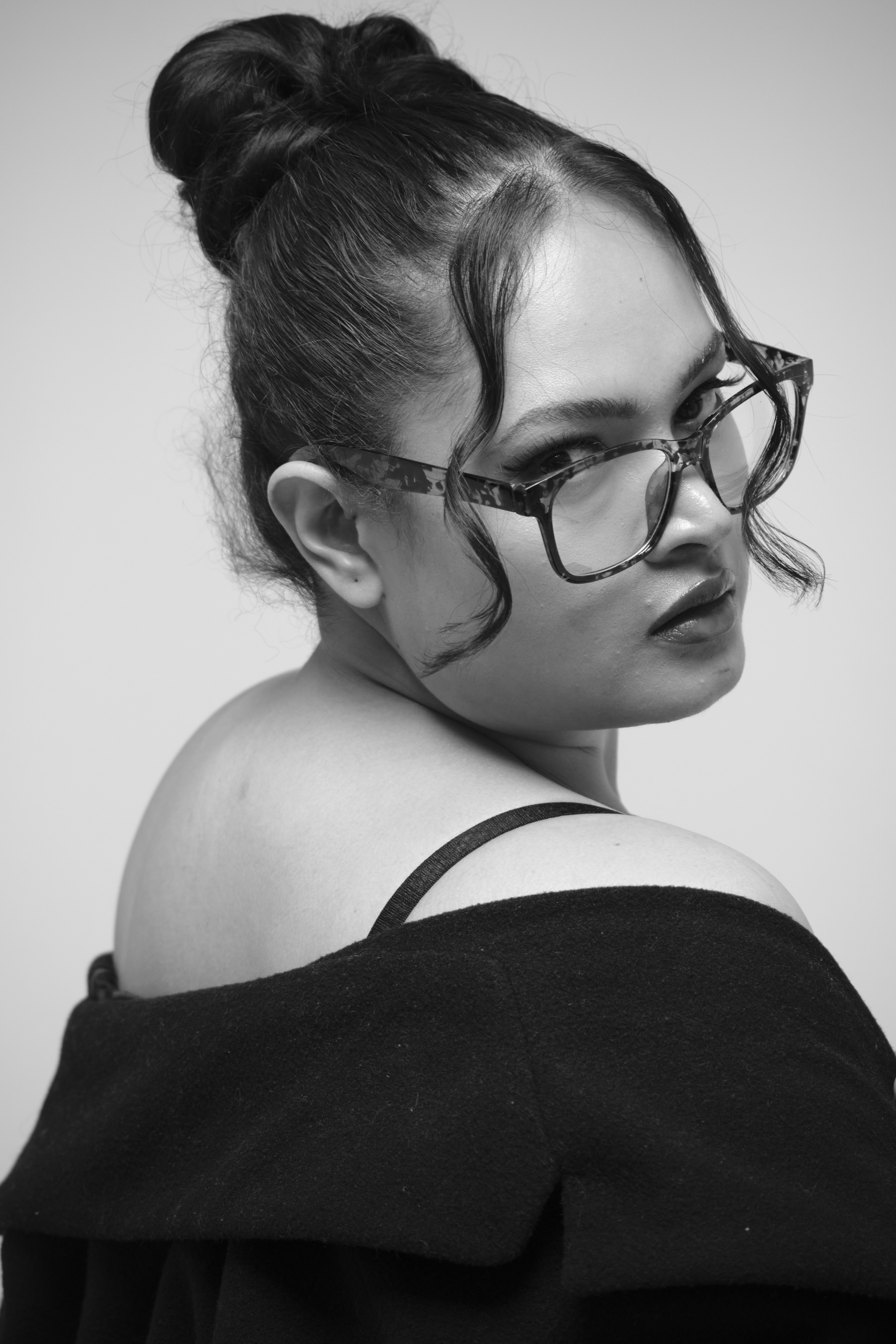 Over-the-shoulder beauty portrait of a model in black and white